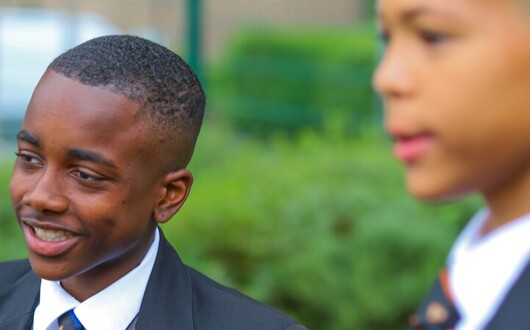 This is an image of 2 pupils on the school grounds